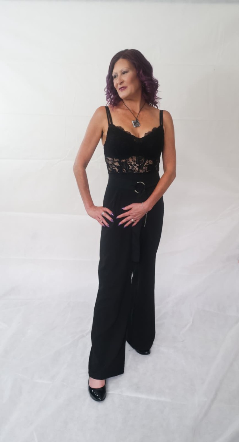 Julie modelling a black lace jumpsuit full length